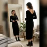 Woman in elegant going out outfit checking her reflection in full-length bedroom mirror