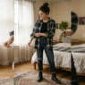 Woman wearing fitted black tank top and oversized red flannel shirt demonstrating grunge outfit foundation layers