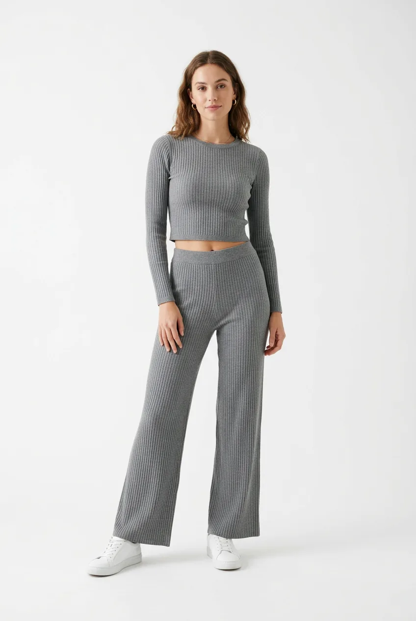 Woman wearing matching gray ribbed knit set with cropped top and wide-leg pants